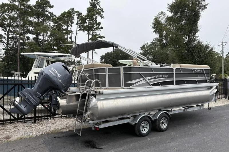 Slide: The Image of 2023 Godfrey Sweetwater 2286 C pontoon boat on trailer with Yamaha outboard motor. - 2