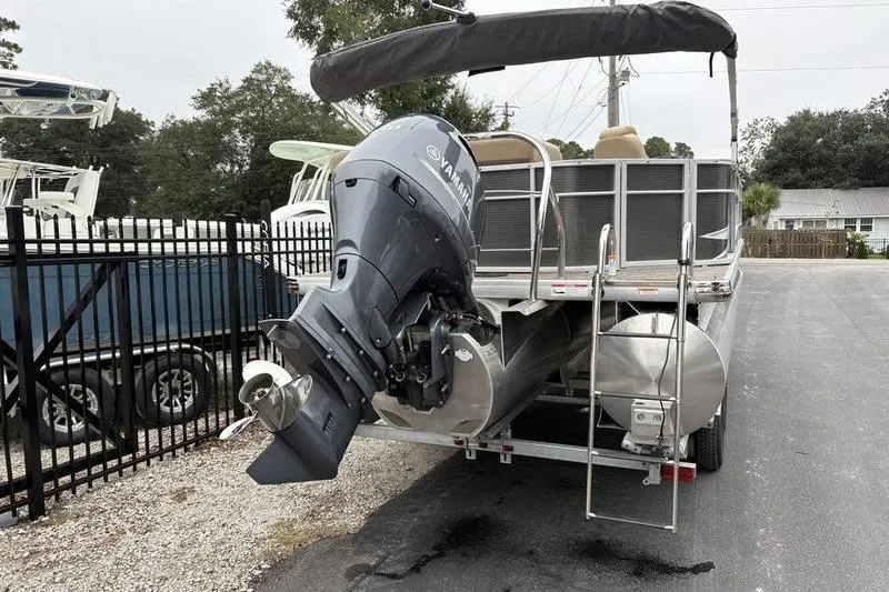 Slide: The Image of 2023 Godfrey Sweetwater 2286 C pontoon boat with Yamaha outboard motor, parked on trailer. - 3