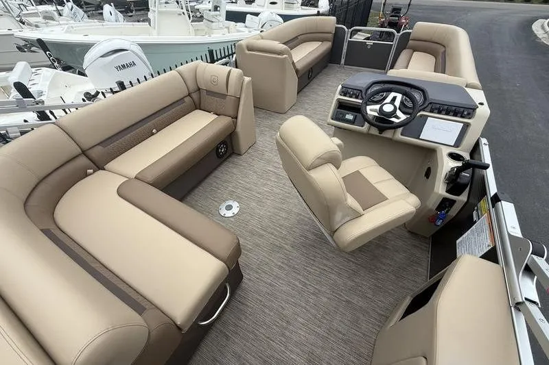 Slide: The Image of 2023 Godfrey Sweetwater 2286 C pontoon boat interior with beige seating and helm. - 4