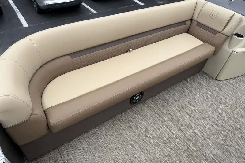 Slide: The Image of 2023 Godfrey Sweetwater 2286 C boat seating, beige and brown upholstery, cup holder, carpeted floor. - 5