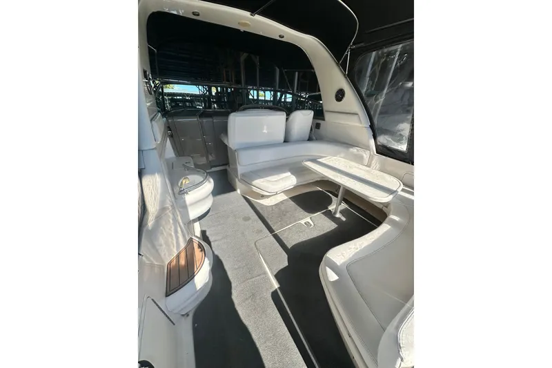 Slide: The Image of Interior of 2000 Sea Ray 310 Sundancer boat with white seating and table. - 11