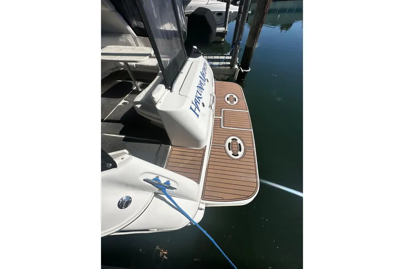 Slide: The Image of 2000 Sea Ray 310 Sundancer boat docked with wooden swim platform. - 12