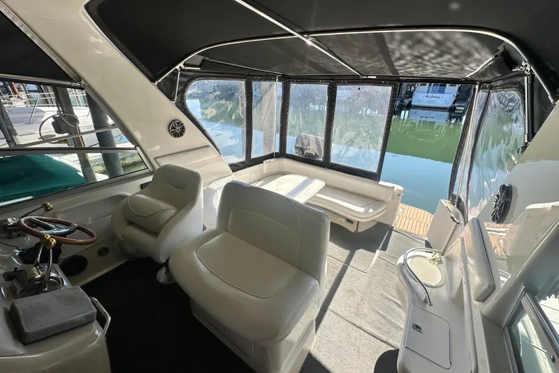 Slide: The Image of Interior of 2000 Sea Ray 310 Sundancer boat with seating and helm station. - 13