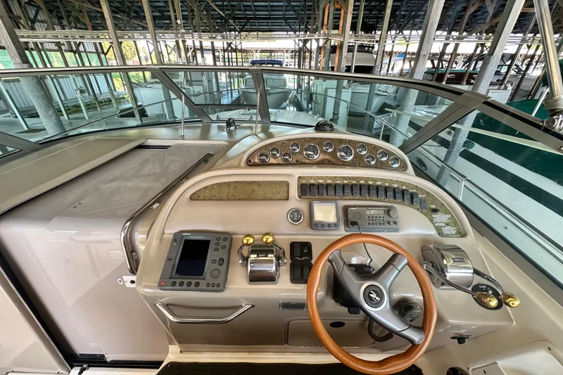 Slide: The Image of Helm of 2000 Sea Ray 310 Sundancer with steering wheel and control panel. - 16