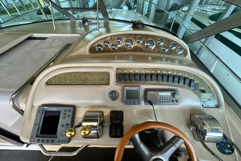 Slide: The Image of Cockpit of 2000 Sea Ray 310 Sundancer with navigation instruments and steering wheel. - 18