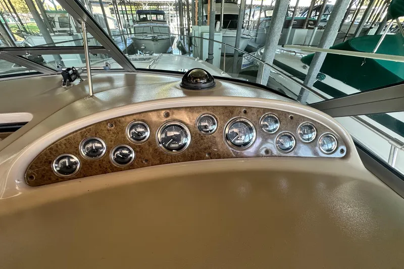Slide: The Image of Dashboard of a 2000 Sea Ray 310 Sundancer boat with multiple gauges. - 19