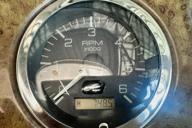Slide: The Image of Close-up of a Sea Ray 310 Sundancer 2000 RPM gauge displaying 748.5 hours. - 23