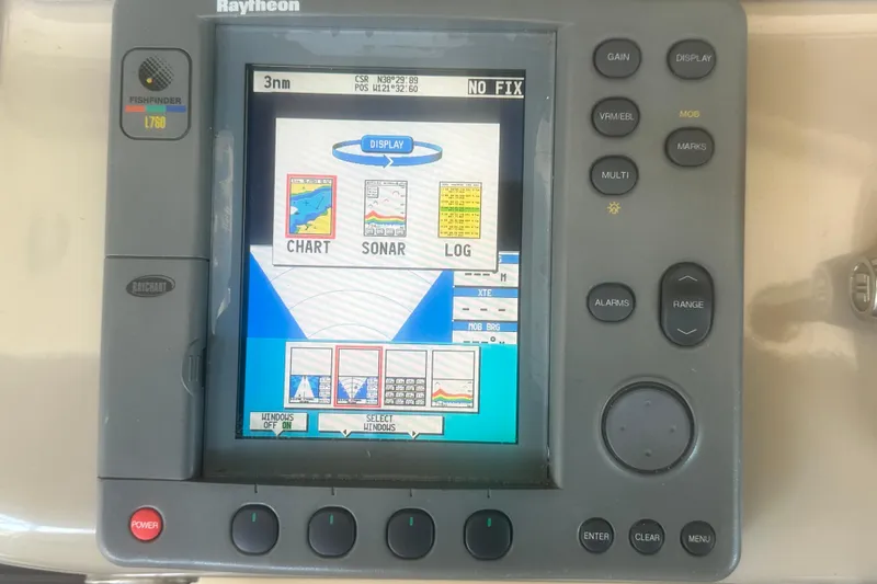 Slide: The Image of Raytheon marine navigation system on 2000 Sea Ray 310 Sundancer, displaying chart, sonar, and log. - 27