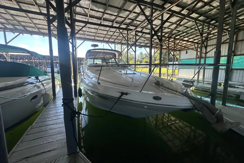 Slide: The Image of 2000 Sea Ray 310 Sundancer docked in a covered marina. - 3