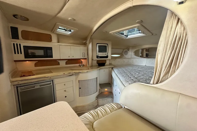 Slide: The Image of Interior of 2000 Sea Ray 310 Sundancer yacht with kitchenette and sleeping area. - 31