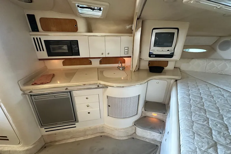 Slide: The Image of Interior of 2000 Sea Ray 310 Sundancer with kitchenette and sleeping area. - 33