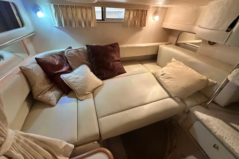 Slide: The Image of Interior of 2000 Sea Ray 310 Sundancer with cozy seating and decorative pillows. - 38