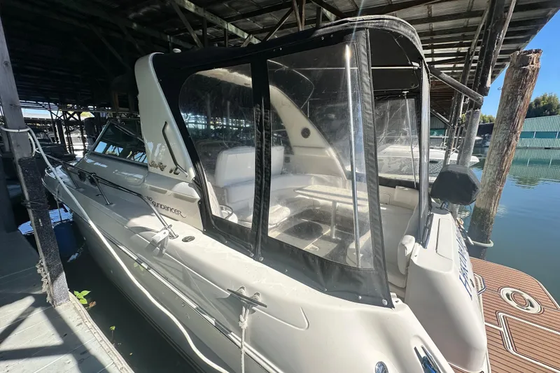 Slide: The Image of 2000 Sea Ray 310 Sundancer docked under a covered marina. - 4