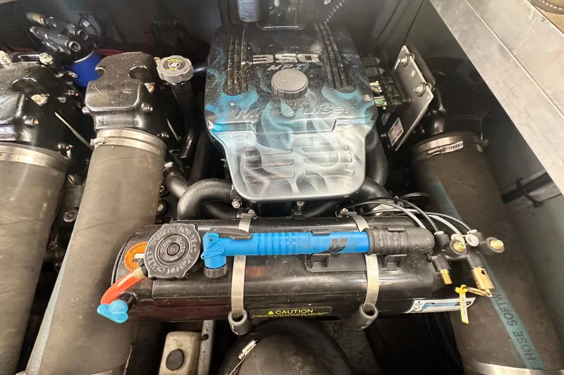 Slide: The Image of Engine compartment of a 2000 Sea Ray 310 Sundancer boat, featuring a 350 MPI motor. - 48