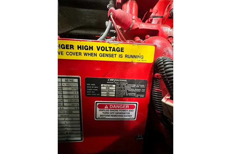Slide: The Image of Sea Ray 310 Sundancer 2000 generator with high voltage warning label. - 53