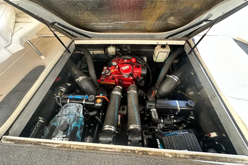 Slide: The Image of Engine compartment of a 2000 Sea Ray 310 Sundancer boat, showcasing detailed components. - 54