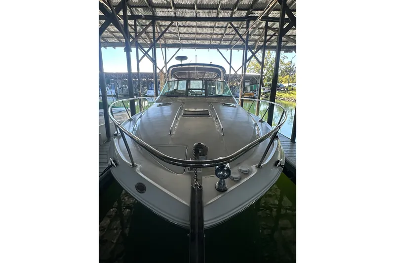 Slide: The Image of 2000 Sea Ray 310 Sundancer docked under a covered marina. - 7