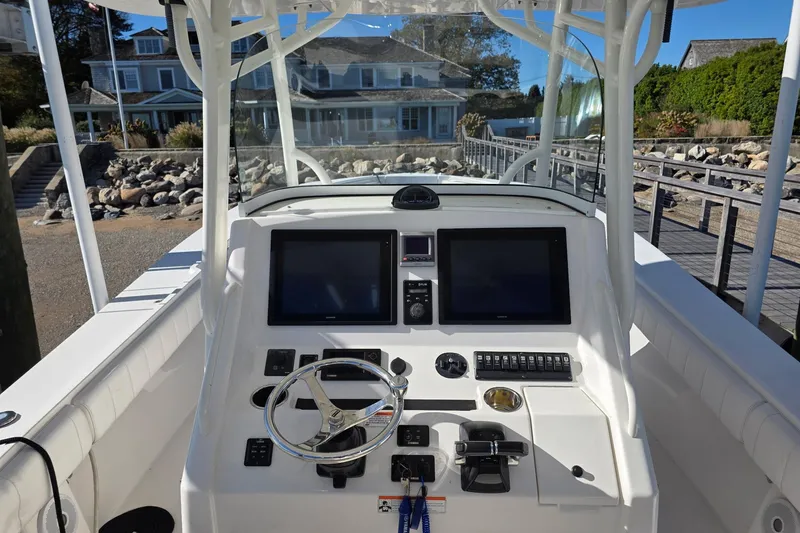 Slide: The Image of 2014 Regulator 34 boat cockpit with dual screens and steering wheel. - 11