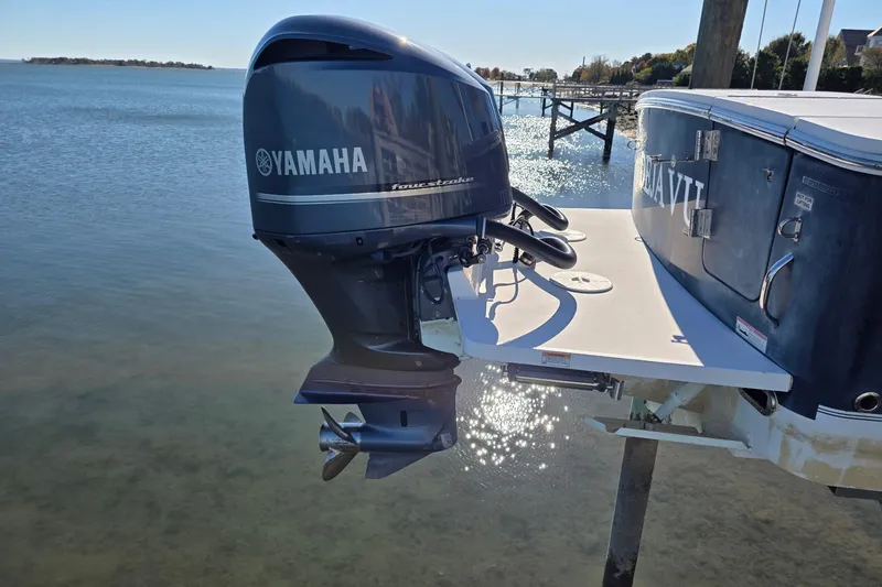 Slide: The Image of 2014 Regulator 34 boat with Yamaha outboard motor on calm water. - 4