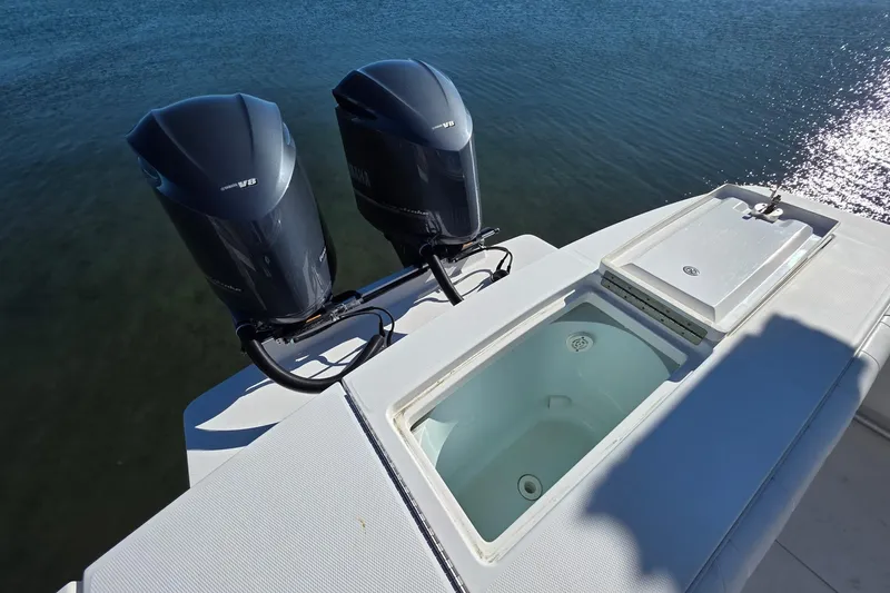 Slide: The Image of 2014 Regulator 34 boat with twin V8 engines and open storage compartment. - 6