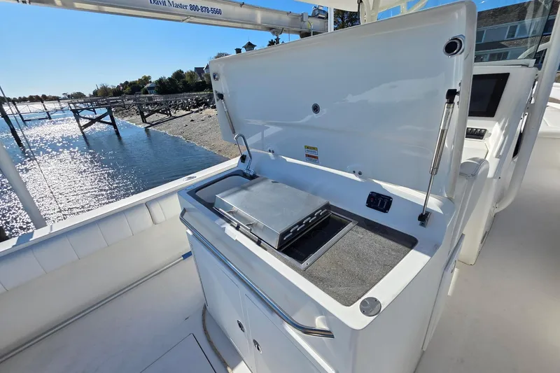 Slide: The Image of 2014 Regulator 34 boat with open grill station, dockside view. - 9