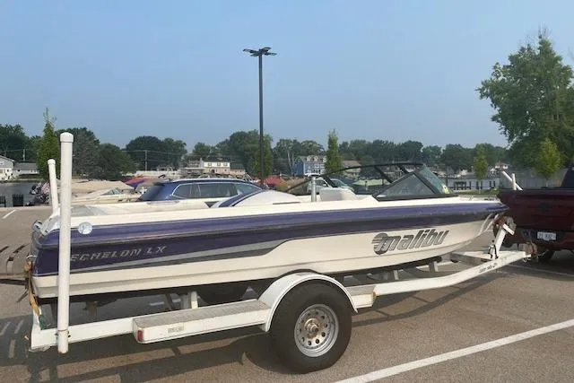 Slide: The Image of 1997 Malibu Echelon boat on trailer in parking lot, side view. - 2