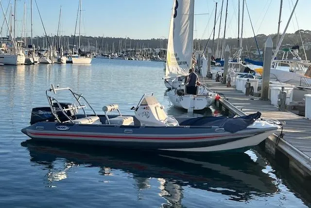 The Image of 2001 Hysucat 650 boat docked in a marina with sailboats in the background. - 1