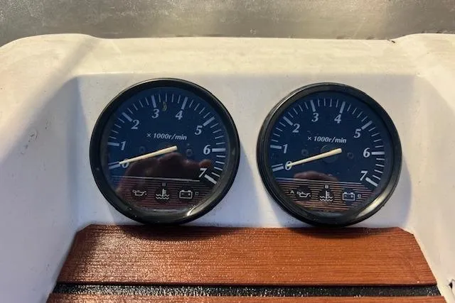Slide: The Image of Dashboard of a 2001 Hysucat 650 boat with dual tachometers. - 12