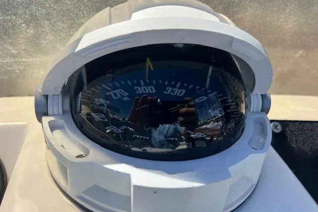 Slide: The Image of Compass on a 2001 Hysucat 650 boat, reflecting surroundings. - 13