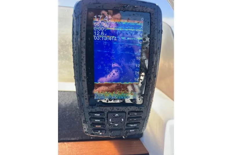 Slide: The Image of Close-up of a wet marine GPS device on a 2001 Hysucat 650 boat. - 14