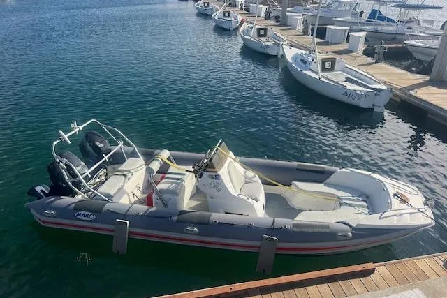 Slide: The Image of 2001 Hysucat 650 boat docked at marina, featuring sleek design and spacious seating. - 3