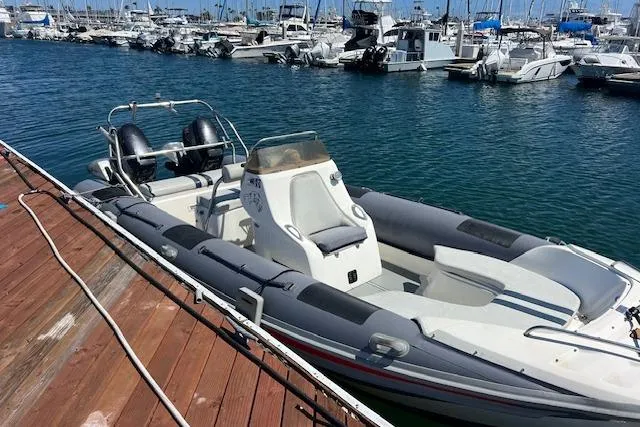 The Image of Hysucat 650 boat from 2001 docked in a marina with other vessels. - 0