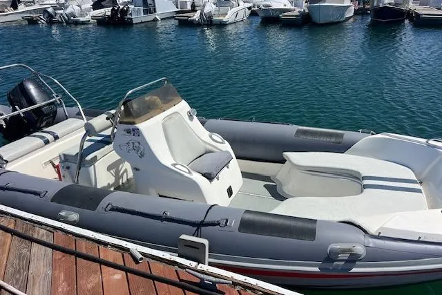 Slide: The Image of 2001 Hysucat 650 boat docked in a marina, featuring sleek design and spacious seating. - 11