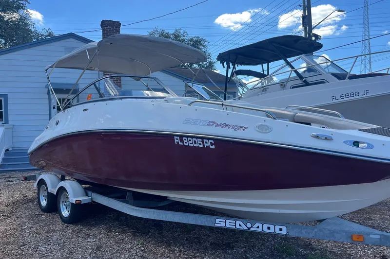 The Image of 2010 Sea-Doo 230 Challenger SP boat on trailer, parked outdoors. - 0