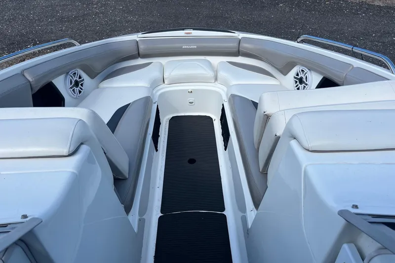 Slide: The Image of 2010 Sea-Doo 230 Challenger SP boat interior with cushioned seating and speakers. - 2