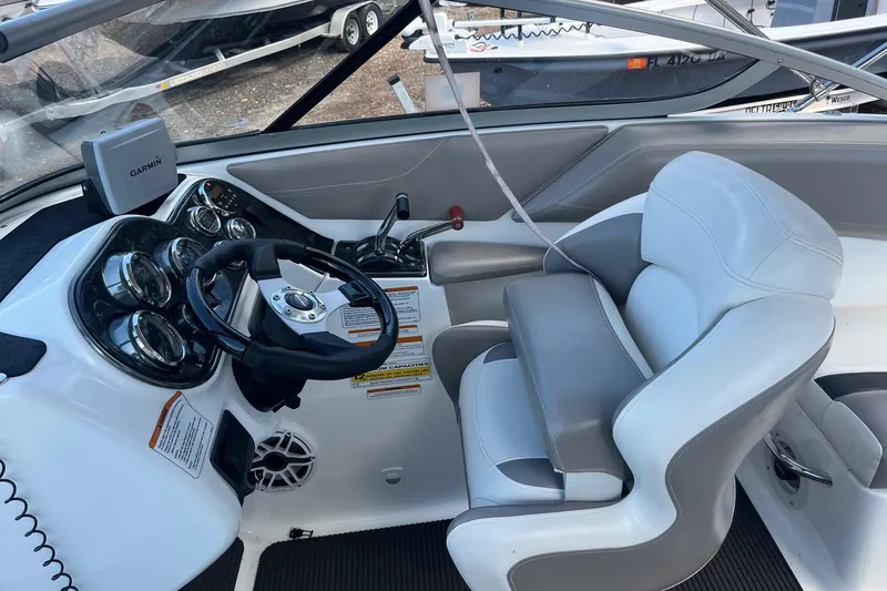 Slide: The Image of 2010 Sea-Doo 230 Challenger SP cockpit with steering wheel, gauges, and Garmin device. - 4