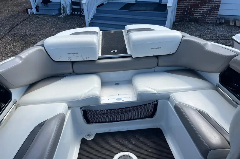 Slide: The Image of 2010 Sea-Doo 230 Challenger SP boat interior with gray seating and storage compartments. - 6