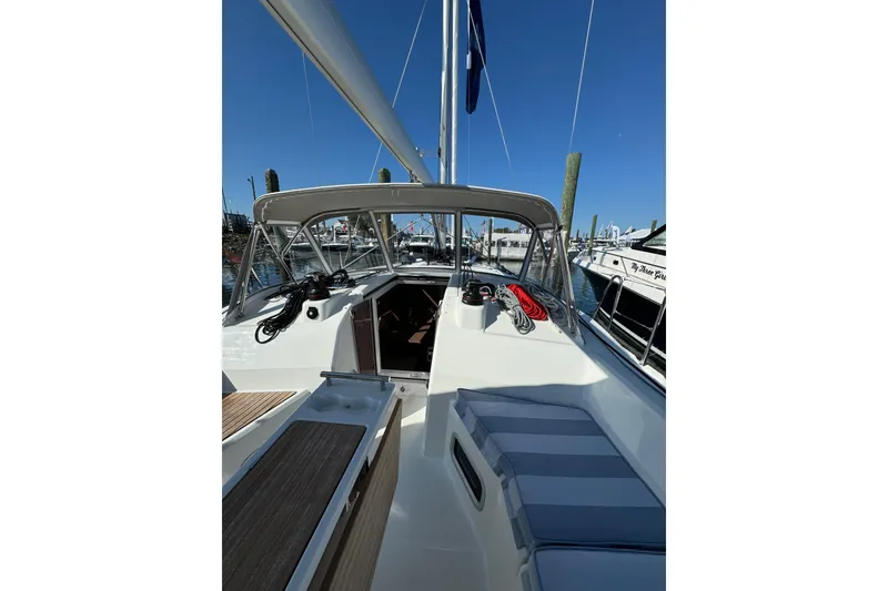 Slide: The Image of 2024 Beneteau Oceanis 37.1 sailboat cockpit with seating and equipment, docked at marina. - 13