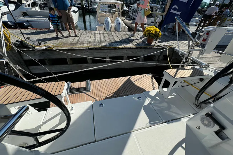 Slide: The Image of 2024 Beneteau Oceanis 37.1 yacht docked, showcasing deck and marina view. - 14