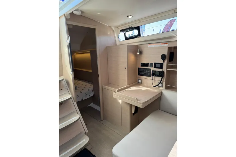 Slide: The Image of 2024 Beneteau Oceanis 37.1 interior with navigation station and cozy cabin. - 15