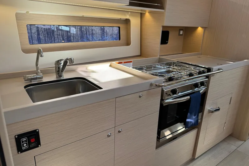 Slide: The Image of Modern kitchen in 2024 Beneteau Oceanis 37.1 yacht with sink and stove. - 16