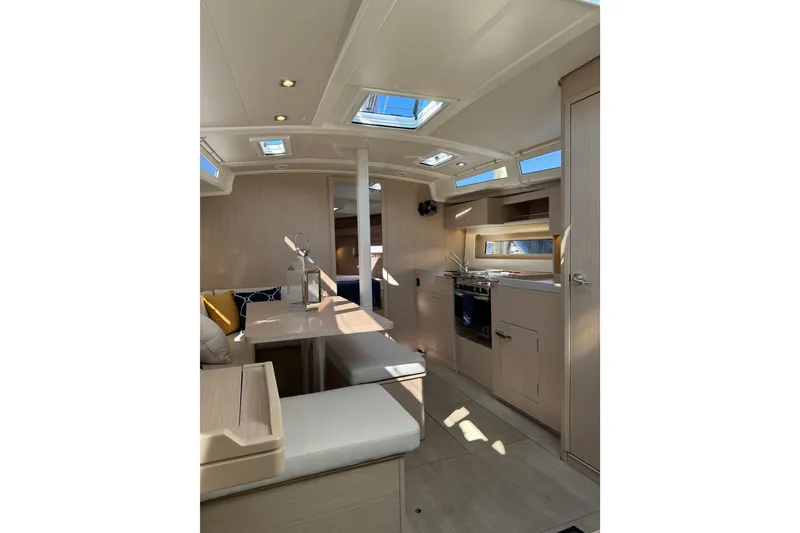 Slide: The Image of Interior of 2024 Beneteau Oceanis 37.1 yacht, featuring modern kitchen and seating area. - 17