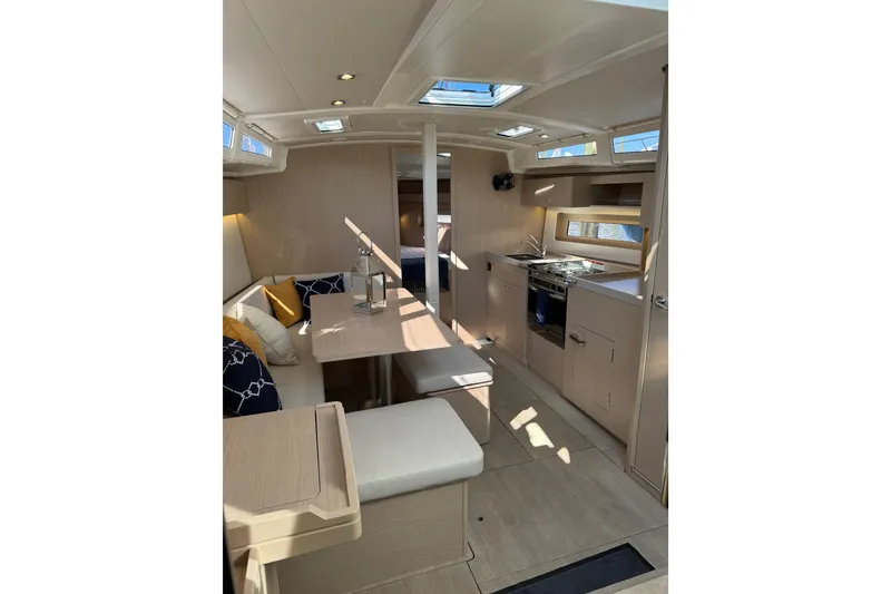Slide: The Image of 2024 Beneteau Oceanis 37.1 yacht interior with modern kitchen and seating area. - 22