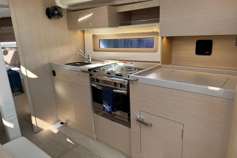 Slide: The Image of Modern kitchen interior of 2024 Beneteau Oceanis 37.1 yacht with sleek wood finish. - 25