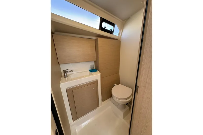 Slide: The Image of 2024 Beneteau Oceanis 37.1 yacht bathroom with modern fixtures and wood accents. - 26