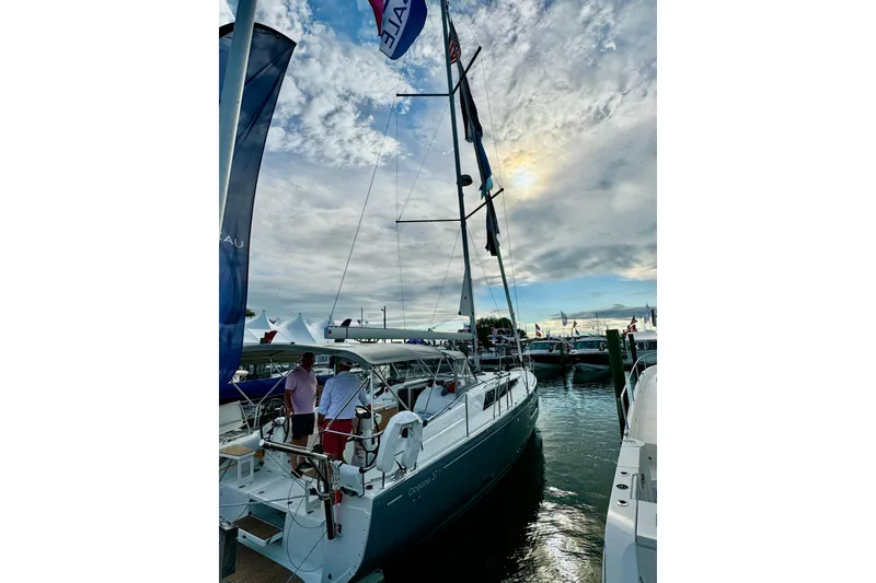 Slide: The Image of 2024 Beneteau Oceanis 37.1 sailboat docked at marina under cloudy sky. - 7