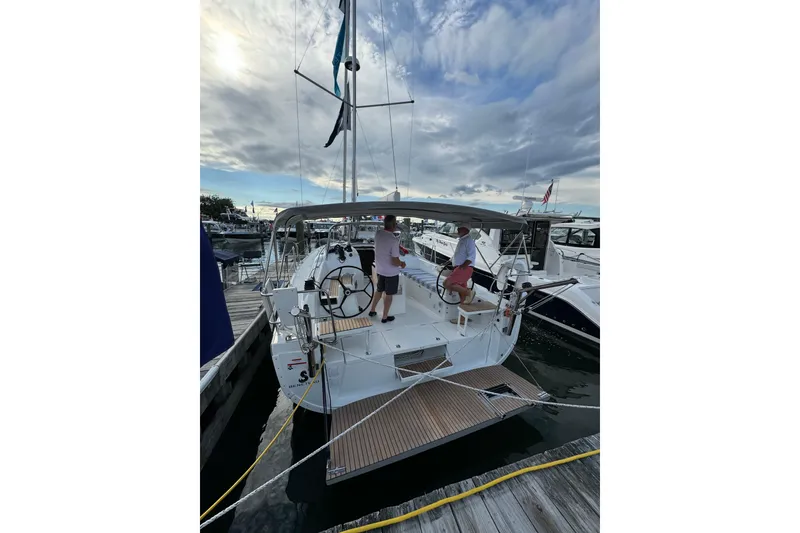 Slide: The Image of 2024 Beneteau Oceanis 37.1 sailboat docked at marina under cloudy sky. - 9