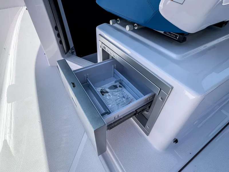 Slide: The Image of Open storage drawer on 2024 Axopar 37 Sun Top boat, showcasing sleek design and functionality. - 5