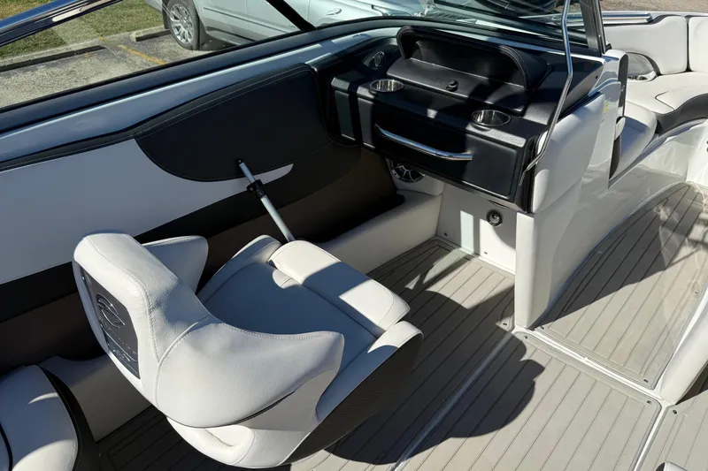 Slide: The Image of 2023 Crownline 240 SS SURF boat interior with sleek seating and modern dashboard design. - 14