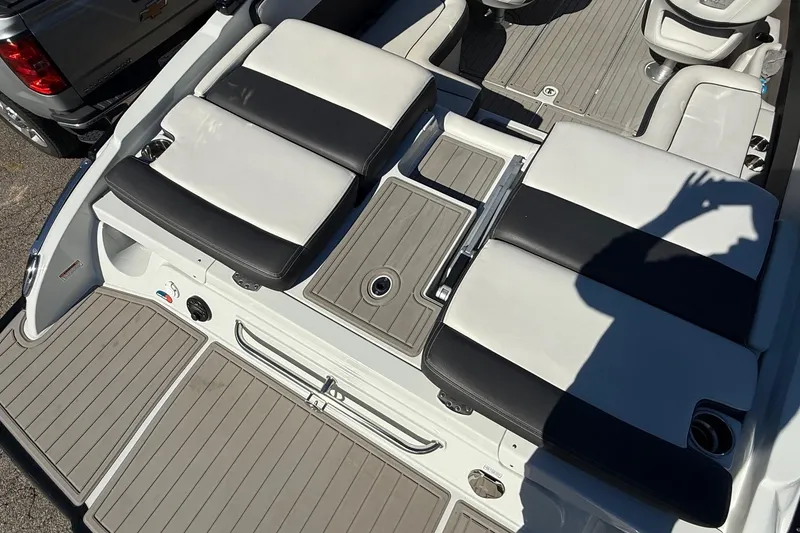 Slide: The Image of 2023 Crownline 240 SS SURF boat interior with cushioned seating and deck details. - 15